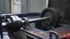 Industrial steel shaft, pulley, and bearing detail on heavy machinery, showing power transmission components and wear. - Powered by Shutterstock - Get 15% off with code: PIKWIZARD15