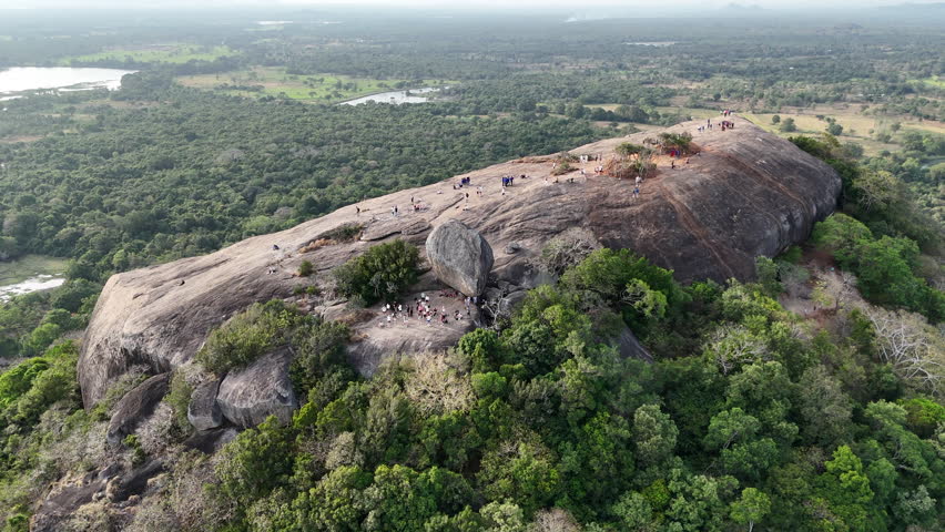 Drone shot of Pidurangala mountain peak surrounded by jungle