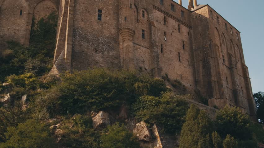 Abbey Mont Saint-Michel Normandy. ancient Medieval Village island of saint michel castle in france. architectural buildings structures stone walls, view from outside inside, roofs stairs fortress city