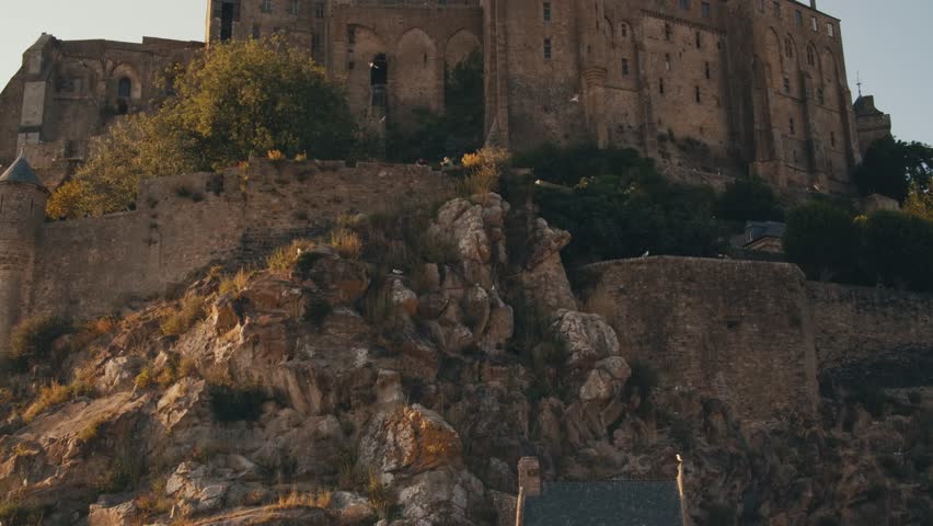 Abbey Mont Saint-Michel Normandy. ancient Medieval Village island of saint michel castle in france. architectural buildings structures stone walls, view from outside inside, roofs stairs fortress city