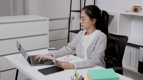 asian female entrepreneur working remotely reading business documents checking data on laptop sitting at modern desk at home office wearing glasses looking serious focused on planning project - Powered by Shutterstock - Get 15% off with code: PIKWIZARD15