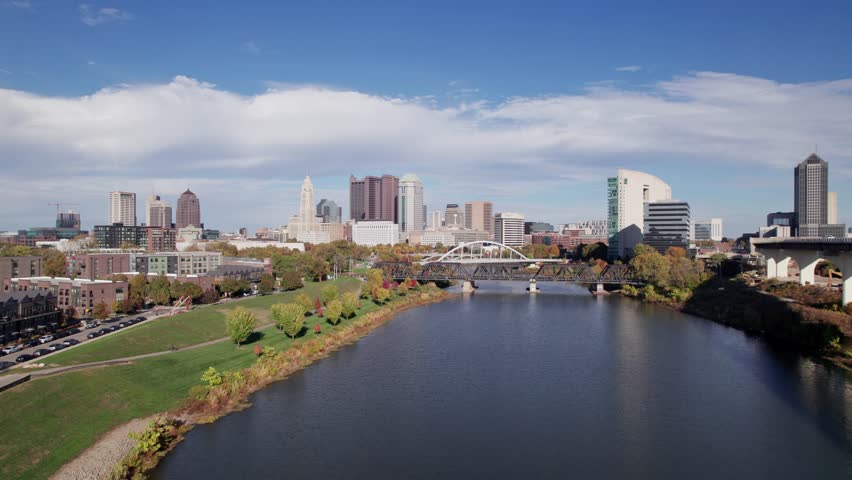 American midwestern city buildings, towers, and business of Columbus, OH in central Ohio with Scioto Mile, Franklinton, and downtown center buildings along river during a sunny fall and autumn day