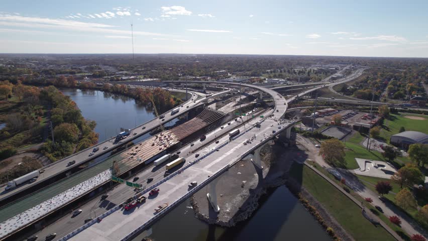Aerial view and drone shot above new American highway, multi-lane roadway, and car traffic on road under construction and being built above old infrastructure in Columbus, Ohio downtown city area