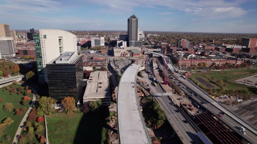 Aerial view and drone shot above new American highway, multi-lane roadway, and car traffic on road under construction and being built above old infrastructure in Columbus, Ohio downtown city area