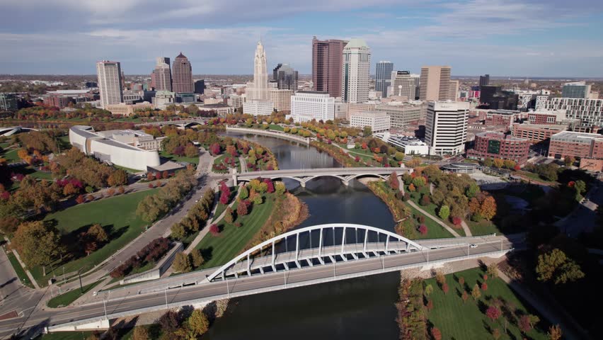 American midwestern city buildings, towers, and business of Columbus, OH in central Ohio with Scioto Mile, Franklinton, and downtown center buildings along river during a sunny fall and autumn day