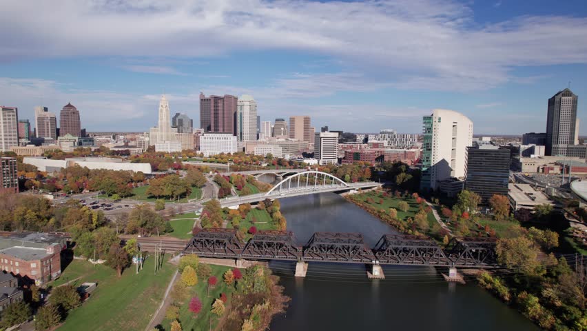 American midwestern city buildings, towers, and business of Columbus, OH in central Ohio with Scioto Mile, Franklinton, and downtown center buildings along river during a sunny fall and autumn day