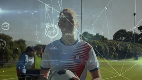 Female soccer player holding ball, staring as HUD network appearing over face, smiling for training. Athlete, teamwork, outdoor, field, jersey, vibrant, futuristic - Powered by Shutterstock - Get 15% off with code: PIKWIZARD15