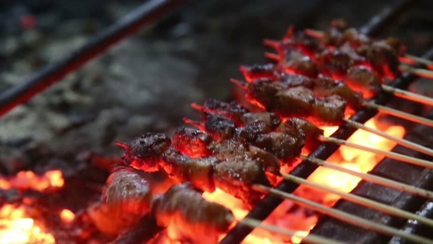 Juicy grilled skewers cooked over blazing charcoal, showcasing sizzling texture, smoky aroma, and vibrant street-food vibes perfect for culinary and food-content visuals.