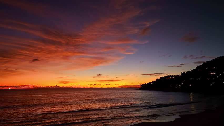 Time lapse The golden twilight settles over the tranquil shoreline, painting soft reflections on the still water. The beauty of dusk whispers peace as day transforms into a dreamlike night.