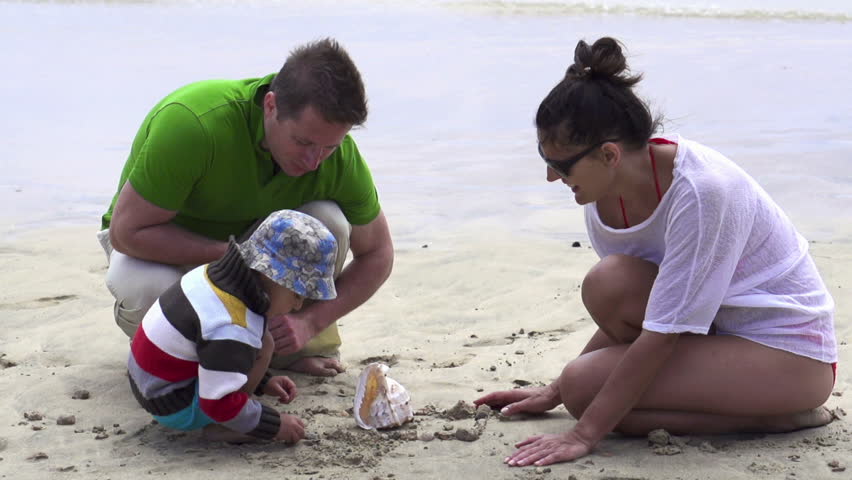 Family on beach with beautiful seashell, super slow motion, shot at 240fps
