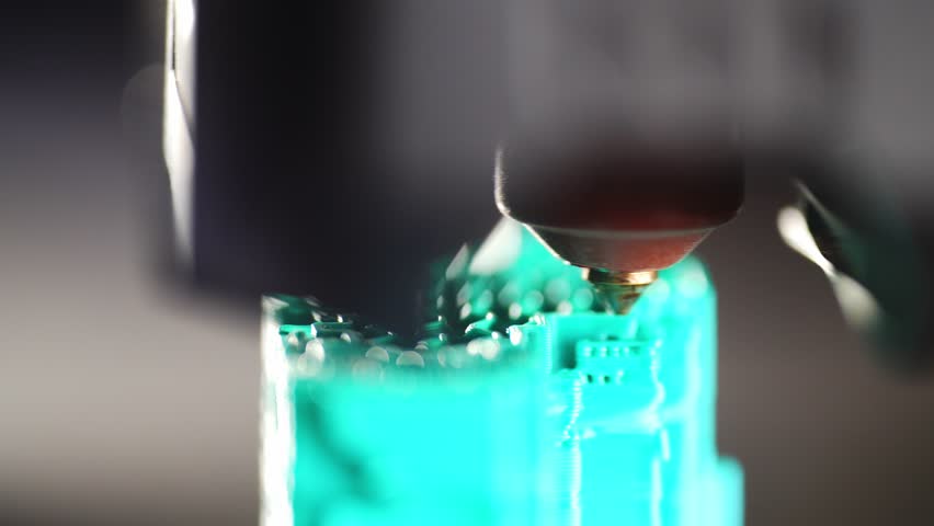 A close-up shows the detailed operation of a 3D printer during printing. High quality 4k footage