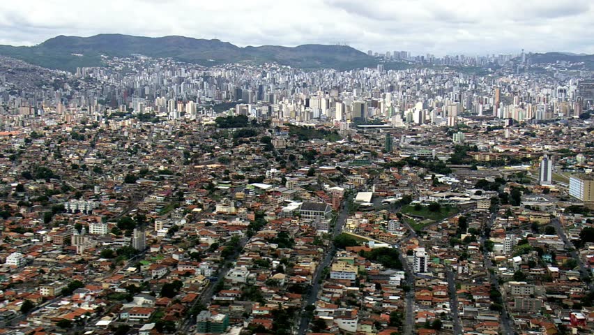Expansive aerial view of Belo Horizonte cityscape with mountains in the distance