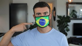 Man using a protective breathing mask with the Brazilian flag on it  - Powered by Shutterstock - Get 15% off with code: PIKWIZARD15