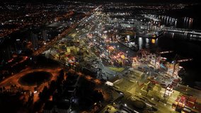 Illuminated mersin port at night with container ships, gantry cranes and busy cargo terminals against a glowing cityscape, highlighting global shipping and logistics - Powered by Shutterstock - Get 15% off with code: PIKWIZARD15