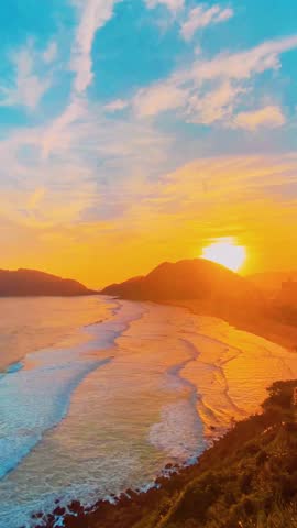 Vibrant Sunrise Motivation: Orange Glow Over the Coastal Waves