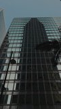 Highrise building with glass facade and tower shadow in Hong business city downtown vertical shot. Business facility modern skyscraper in megapolis cityscape. Urban architecture - Powered by Shutterstock - Get 15% off with code: PIKWIZARD15