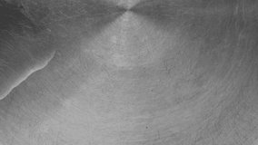 Water droplets hitting the surface of a scratched stainless steel basin, forming ripples and splashes with a metallic texture and reflections - Powered by Shutterstock - Get 15% off with code: PIKWIZARD15