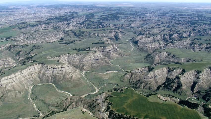 Aerial view of Theodore Roosevelt National Park with green hills and badlands