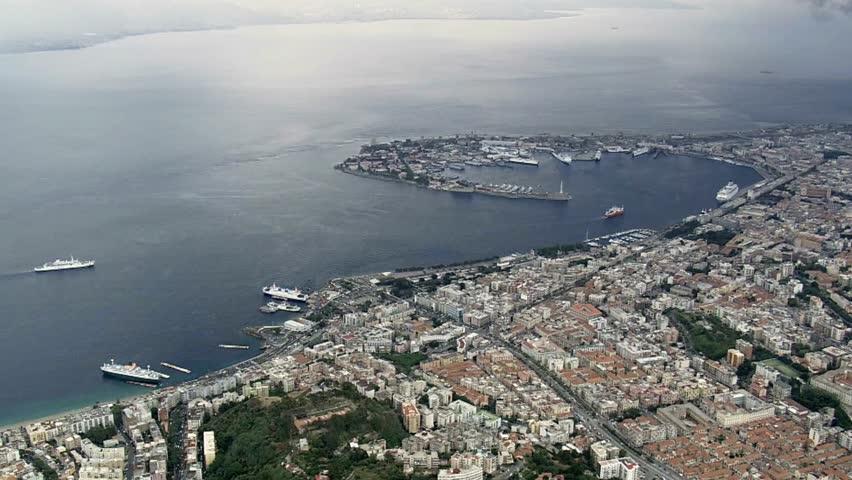 Aerial view of Messina Italy showcasing the city coastline and harbor activity