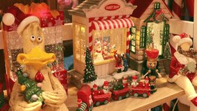 christmas toy shop display with festive figurines, nutcracker, santa, train and candy house in warm holiday lights, concept of christmas decorations, gift shopping, festive celebration - Powered by Shutterstock - Get 15% off with code: PIKWIZARD15