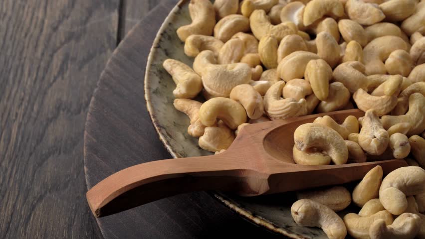 Dolly shot of bowl filled with cashew nuts