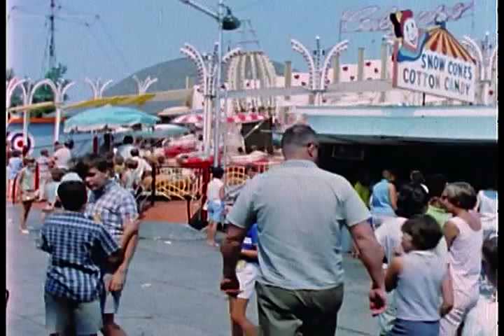 1950s - A person tries to take photos of a woman on a teacup ride in an amusement park.
