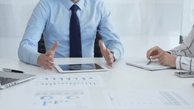 Business colleagues strategizing in modern workspace, reviewing financial analytics on digital devices, sharing insights through collaborative teamwork and data driven discussion - Powered by Shutterstock - Get 15% off with code: PIKWIZARD15