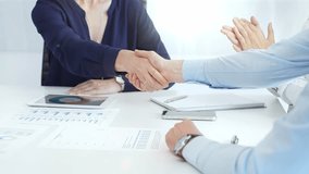 Business executives shaking hands, colleagues clapping after sealing significant partnership, expressing professional success and collaborative achievement in corporate environment. Handshake close up - Powered by Shutterstock - Get 15% off with code: PIKWIZARD15