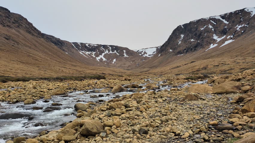 At the end of the Tablelands trail, the Winter House Brook Canyon with serpentine rock and the Tablelands mountain in background, in the Gros Morne National Park (Bonne Bay, Newfoundland, Canada)