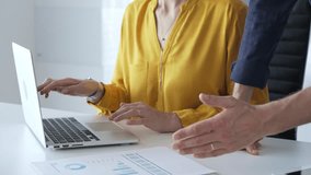 Professional team reviewing financial data on laptop, analyzing charts and strategizing corporate workflow, collaborating toward shared business objectives. Business people concept - Powered by Shutterstock - Get 15% off with code: PIKWIZARD15