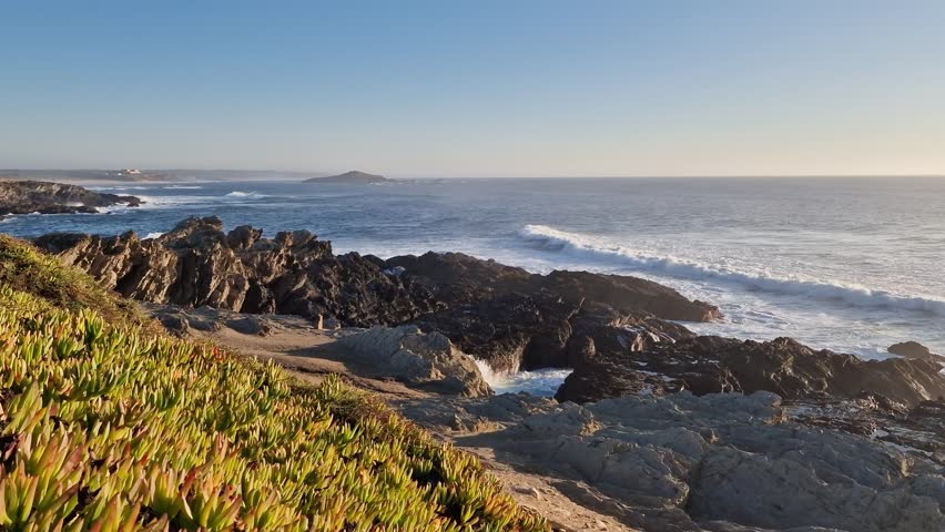 Rugged coastlines with roaring surf and greenery, Untouched coastline showcasing soaring sea cliffs alongside turbulent waters and dense Sines Portugal