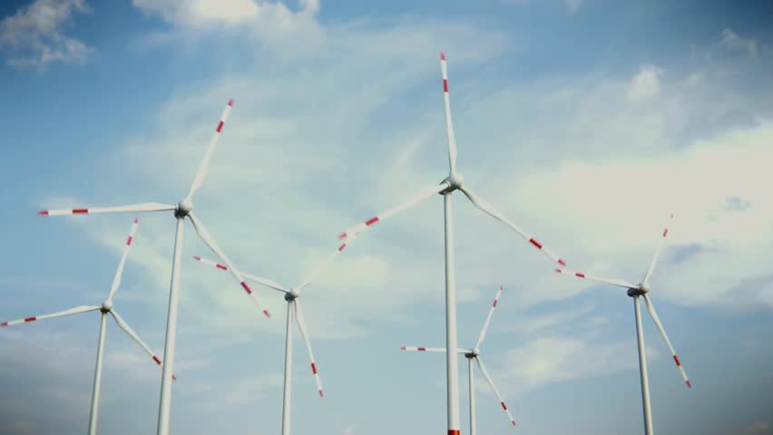 wind turbines spin powerfully beneath a vast, cloudy sky, symbolizing clean energy generation and environmental progress