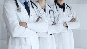 Medical team standing with arms crossed, focusing on healthcare professionals in white lab coats, representing medicine, expertise, and unity in a clinic setting - Powered by Shutterstock - Get 15% off with code: PIKWIZARD15