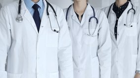 Medical team standing with arms crossed, focusing on healthcare professionals in white lab coats, representing medicine, expertise, and unity in a clinic setting - Powered by Shutterstock - Get 15% off with code: PIKWIZARD15