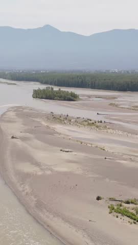 Aerial View of a Vast River Landscape with Sandy Banks and Mountains in British Columbia, Canada
