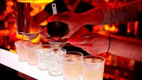 Barman expertly making cocktails with whiskey at a vibrant bar at night, showcasing mixology skills and a lively nightlife atmosphere. - Powered by Shutterstock - Get 15% off with code: PIKWIZARD15