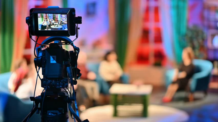 Professional TV camera filming a talk show in a studio, highlighting video production, broadcasting, and media technology in action.