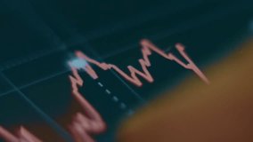 Finger tracing a financial chart showing a downward trend, illustrating stock market decline, investment analysis, and financial data monitoring. - Powered by Shutterstock - Get 15% off with code: PIKWIZARD15