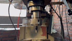 Close-up of a metal milling cutter blade mounted on the machine spindle. The machine can be seen starting to rotate. - Powered by Shutterstock - Get 15% off with code: PIKWIZARD15