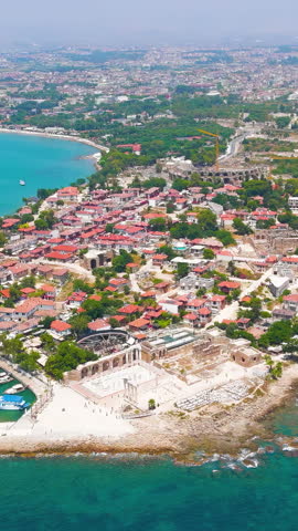 Vertical video. Side, Manavgat, Turkey. Historic peninsula with ancient ruins along Mediterranean shore, aerial view in summer daylight, archaeological landscape. Aerial View, Spiral forward. Rich co