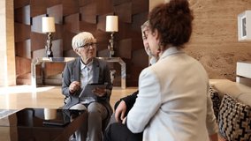 Experienced female executive using a tablet to brainstorm a business plan with her diverse team of coworkers in a contemporary office setting - Powered by Shutterstock - Get 15% off with code: PIKWIZARD15