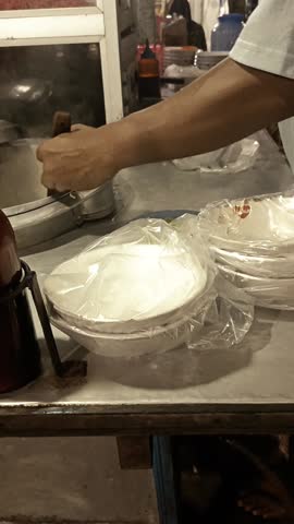 video of a chicken noodle seller serving chicken noodles