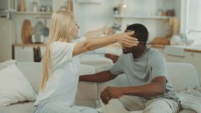 Lovers making peace after quarrel, blonde woman and black man embracing on couch . Happy relationship and interracial marriage, tender embrace and love, african american and caucasian ethnicity - Powered by Shutterstock - Get 15% off with code: PIKWIZARD15
