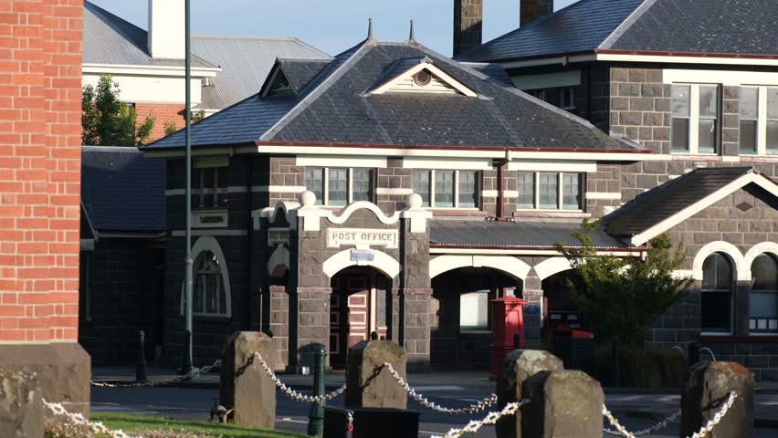 The historic post office building in Camperdown, Victoria, Australia, featuring locally quarried bluestone and classic architectural details. A landmark civic building in the Australian regional town