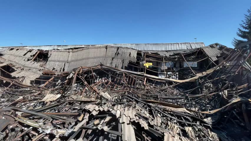 Smoldering wreckage of a warehouse or large commercial building destroyed by a catastrophic fire