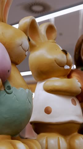 Easter sale. Different funny Easter bunny figurines, statuettes. shopping of Easter decoration for home. Easter decorations and gifts in the shop, supermarket.