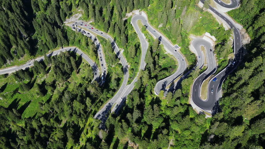 Aerial view of Maloja Pass road in Swiss Alps. Serpentine ascent and descent in mountains, travel and tourism in Europe dangerous routes.