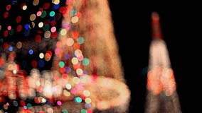 A beautifully blurred shot captures two Christmas trees at night, their colorful, twinkling lights creating a festive bokeh effect against the dark background. - Powered by Shutterstock - Get 15% off with code: PIKWIZARD15