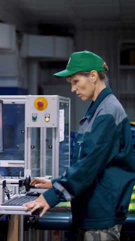 Worker of printing equipment, adjusts, regulates the printing process. working process of printing packages for grain, agricultural products.