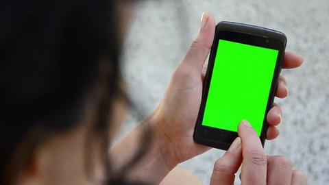 Business woman using a Smart phone Touchscreen CHROMA KEY- Close-up , Fingers make gestures touching and swiping the screen of a modern smartphone. 